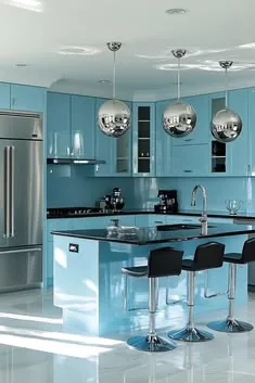 Light-blue kitchen with a dark-top island, black stools and mirrored sphere pendant lights.